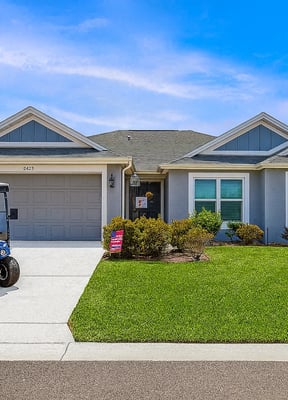 Villages home with golf cart in driveway